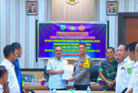 James Uang melakukan melakukan penandatanganan NPHD bersama TNI/POLRI, || Foto: Istimewa